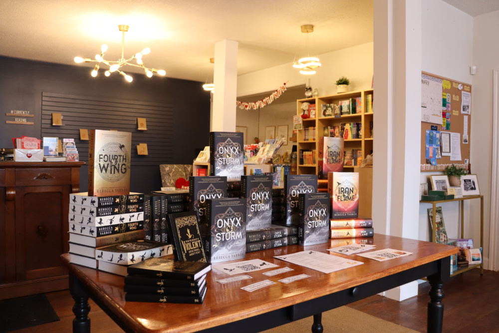 A display table featuring a book series stacked together with bright lights in the background