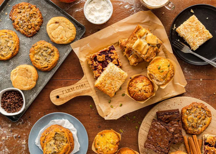 birds eye view of baked goods on trays, plates on a table